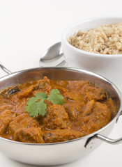 Wall Mural - Indian Meat Madras served with pilau rice on a white background