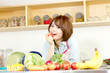 © one - Beautiful young woman in kitchen making salad. Portrait of asian