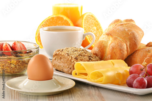 Fototapeta na wymiar Breakfast with coffee, rolls, egg, orange juice, muesli and chee