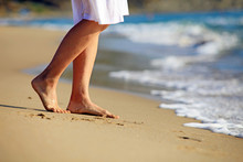 Cropped Image Of A Young Woman Walking On A Beach