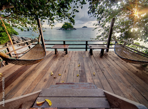 Naklejka ścienna Seculed terrace with wooden hammocks