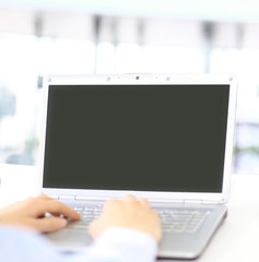 Person Typing on a modern laptop in an office