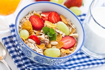 Wall Mural - Breakfast with strawberry muesli and orange juice