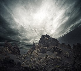 Poster - Dramatic sky over rocks.