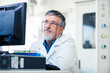 © lightpoet - Senior researche using a computer in the lab