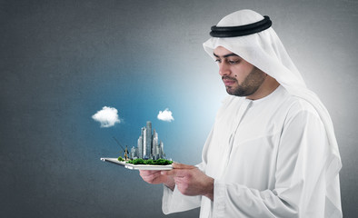 arabian businessman with a virtual city presentation on a pad