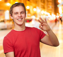 Portrait Of Young Man Doing Good Gesture At Night City
