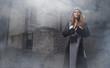 © Acronym - Fashion shoot of a young nun on a foggy background