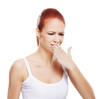 © Acronym - A young and attractive Caucasian redhead woman coughing