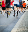 People running in city marathon on street
