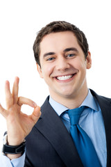 Businessman with okay gesture, isolated