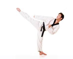 Young man practicing martial arts over white background