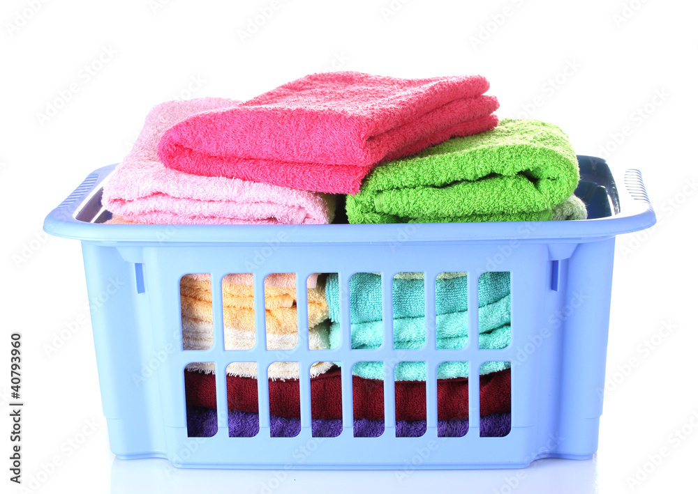 Plastic basket with bright towels isolated on white