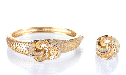 Beautiful golden bracelet and ring with precious stones isolated