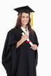 © WavebreakmediaMicro - A smiling woman with her degree as she looks at the camera