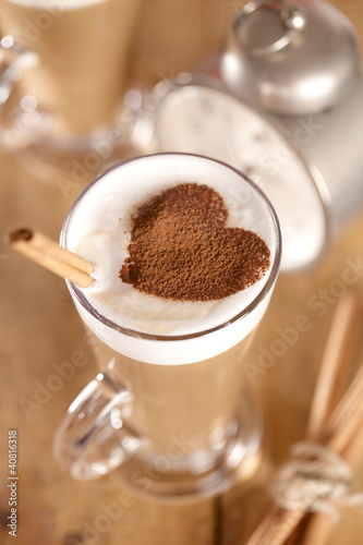 Tapeta ścienna na wymiar coffee latte with cinnamon sticks and cacao heart , shallow dof