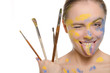 © Andrey Zametalov - woman with brushes and  paint on face shows tongue