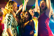 © Kzenon - Party people dancing in disco or club