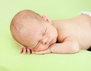 Fototapete - adorable baby sleeping on stomach over green background
