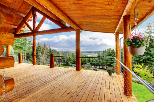 Naklejka na szybę Beautiful view of the log cabin house porch.