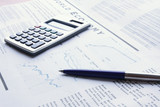 Fototapeta  - pen and calculator on business paper
