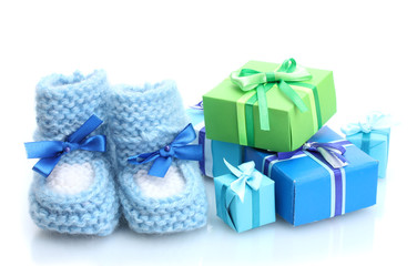 beautiful gifts and baby's bootees isolated on white