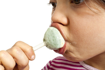 little girl sucking lollipop, close-up studio