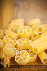 Poster - raw pasta on wood background texture