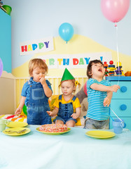 Three kids eating birthday cake