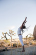© Elena Ray - Yoga Shakti wild fit woman in free form movement in the desert.