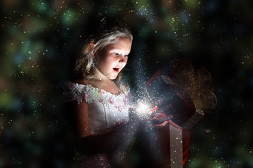 Wall Mural - Child opening a magic gift box