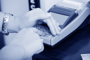 Human hand enter atm banking cash machine pin code