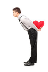 Poster - Man holding a red heart shape object and giving kisses