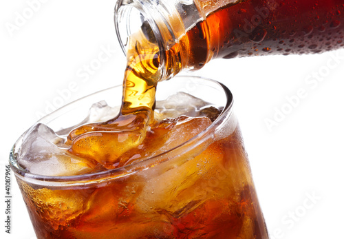 Fotografía Cola is pouring into glass