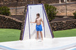 © travelview - boys have fun unter the pool shower