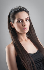 Wall Mural - Portrait of a beautiful girl in stylish glasses, studio shot