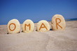 Omar , male name on colourful pebbles