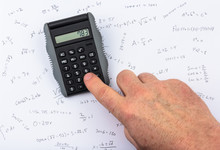 Person Calculating On A Pocket Calculator