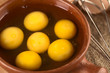 Raw eggs in rustic bowl with beater on the side