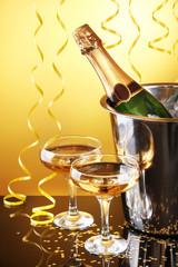 Wall Mural - Champagne bottle in bucket with ice and glasses of champagne,