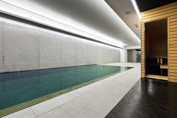 modern concrete house , indoor pool with sauna