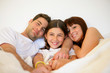© auremar - Couple and daughter in bed