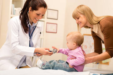 Wall Mural - Pediatrician examine baby with stethoscope