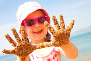 little girl play jn sandy beach