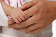© Andy Dean - Baby Girl Hand Holding Rough Finger of Dad