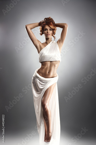 Fototapeta dla dzieci Fashion shoot of a young redhead woman in a beautiful dress