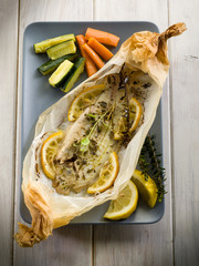 Canvas Print - sole fish cocked in a wrapper with herbs and sliced lemon