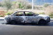 Burned out car in street