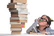 A girl looking at a pile of books