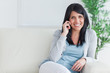 © WavebreakmediaMicro - Woman talking on the phone while resting on a sofa